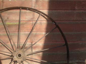 old wheel against barn wall Minnesota photo